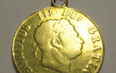A George III Half Sovereign 1817 with attached edge...