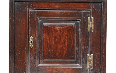 A George III oak mural cupboard, the interior with shelf enc...