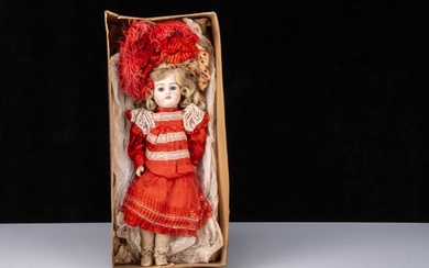 A German 457 bisque head doll in factory dress and box base