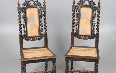 A PAIR OF VICTORIAN CARVED OAK HALL CHAIRS.