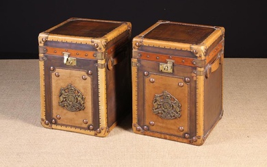 A Pair of Leather Bound Copper Clad Travelling Trunks. The square hinged tops having leather banded