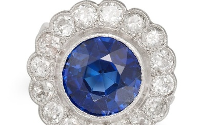 A SYNTHETIC SAPPHIRE AND DIAMOND CLUSTER RING set with a round cut synthetic sapphire in a cluster