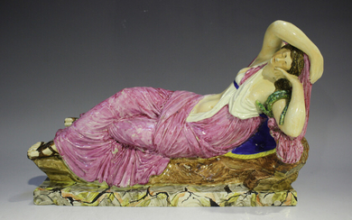 A Staffordshire pearlware figure of Cleopatra or Ariadne, 19th century, modelled as a reclining figu