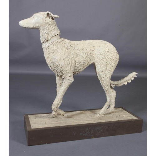 A ceramic figure of a lurcher, on naturalistic base and wood...