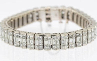 A diamond and 18ct white gold line bracelet with an...