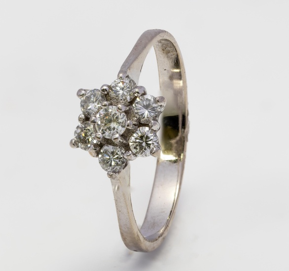A diamond cluster ring and a three stone diamond ring