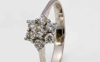 A diamond cluster ring and a three stone diamond ring