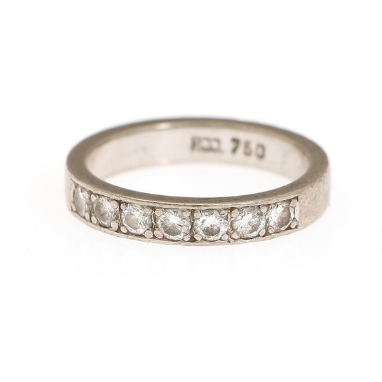 A diamond eternity ring set with seven brilliant-cut diamonds, mounted in 18k white gold. Size 50.
