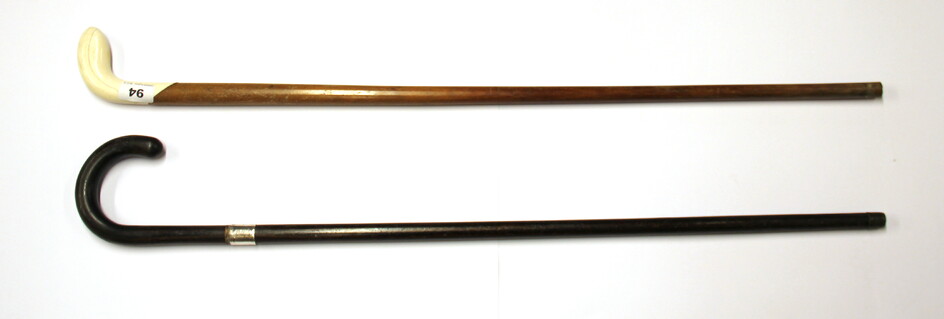 A hallmarked silver mounted walking stick and a further antique walking stick with a marine ivory handle.