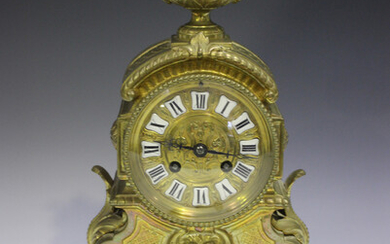 A late 19th century French brass cased mantel clock with eight day movement striking on a bell via a