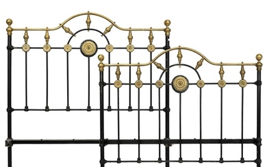 A late Victorian brass and iron double bedstead. The arched ...