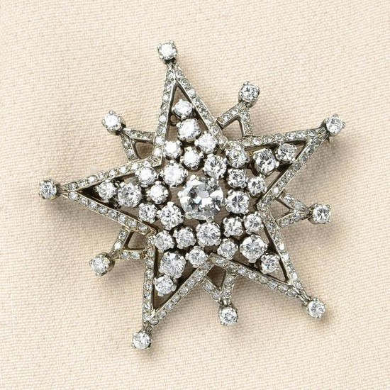 A mid 20th century gold diamond star brooch. Estimated