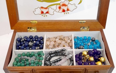 A mini jewellery box with a selection of precious...