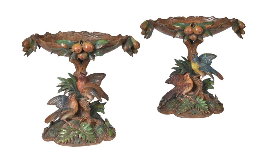 A pair of carved wood and polychrome decorated centrepieces or comports