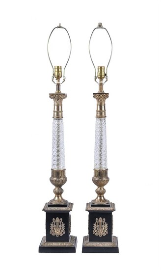 A pair of ebonised, gilt metal mounted, and glass stemmed table lamps