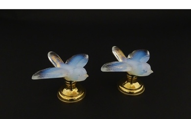 A pair of glass models of swallows raised on French silver g...
