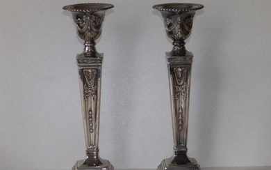 A pair of modern silver candlesticks, of square neoclassical...