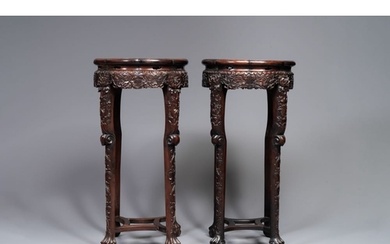 A pair of tall Chinese carved wooden stands with marble tops...