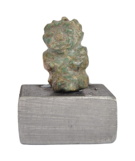 A pre Columbian Mexican stone carved figure. A figure depicting a stone seated figure of small proportions with naively carved features, mounted on a later base. Approximately 6cm tall.