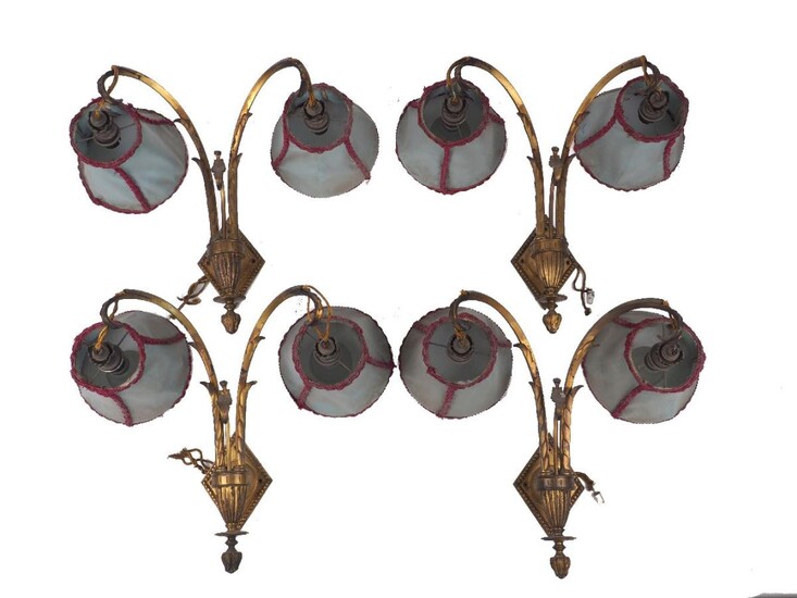 A set of four Edwardian gilt-bronze twin-light wall appliques, early 20th century, each with down-ward scrolling branches and lozenge backplate, 37cm high (4) It is the buyer's responsibility to ensure that electrical items are professionally...