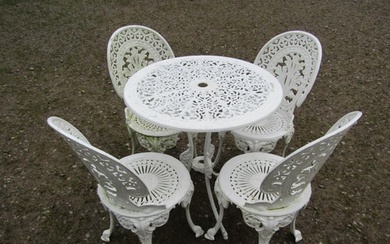 A small cream painted cast alloy garden terrace table with d...