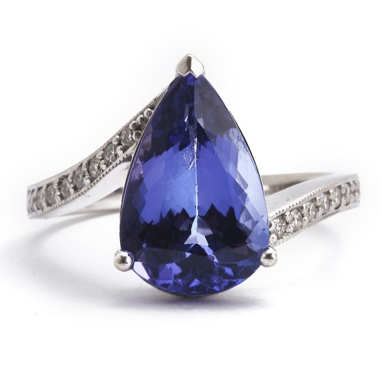 A tanzanite and diamond ring set with a pear-shaped tanzanite and numerous brilliant-cut diamonds, mounted in 18k white gold. Size 55.5.