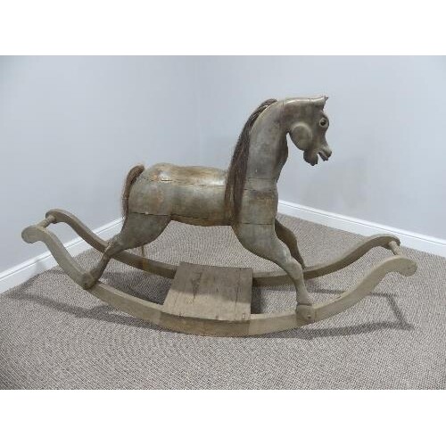 A vintage carved wooden Rocking Horse on bow rockers, with r...