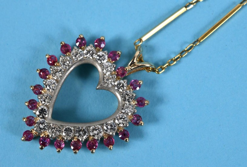 A yellow gold, ruby and diamond heart shaped pendant, on a c...