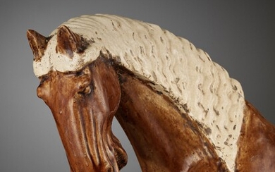AN AMBER-GLAZED POTTERY HORSE WITH WHITE-GLAZED BRAIDED MANE AND TAIL