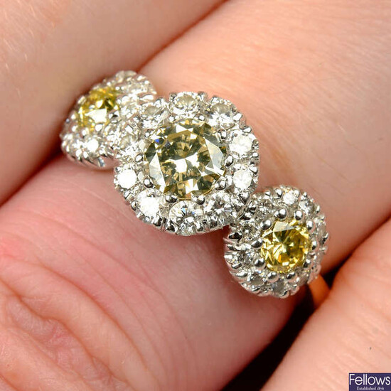 An 18ct gold brilliant-cut 'yellow' diamond and diamond triple cluster ring.