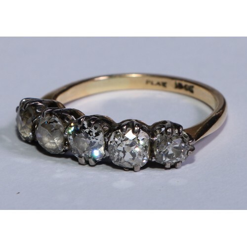 An 18ct gold diamond ring, the platinum bezel set with a row...