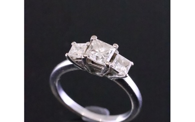 An 18ct white gold three stone diamond ring with an insuranc...