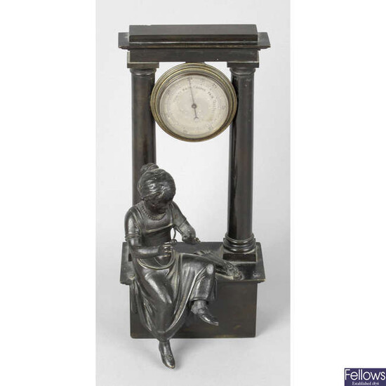 An early 19th Century bronze desk barometer decorated with the figure of a seated young girl.