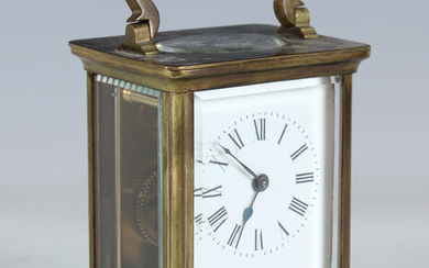 An early 20th century French brass cased carriage timepiece, the case with bevelled glass panels and