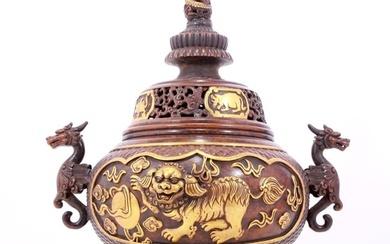 An exquisite gilt bronze censer with double ears and three legs with a lion and dragon pattern and a