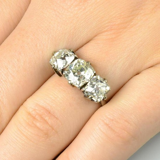An old-cut diamond three-stone ring. Estimated total