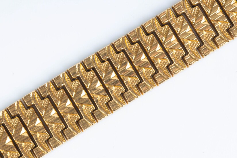 Bracelet articulé en or à motifs géométriques. 20,5 cm, larg. 19 mm. 47,52 g