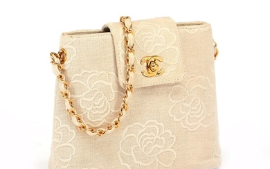 SOLD. Chanel: A bag made of beige canvas with embroidery in the shape of flowers,...