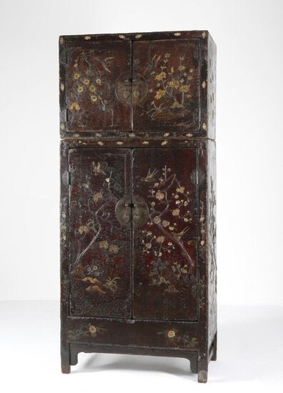 Chinese Art. A rare composite wood lacquered wardrobe (dasijiangui, dingxiang ligui) China, Ming dynasty, early 17th century . An important red lacquered wooden wardrobe with precious and elaborate coral, mother-of-pearl and stones decoration. This...