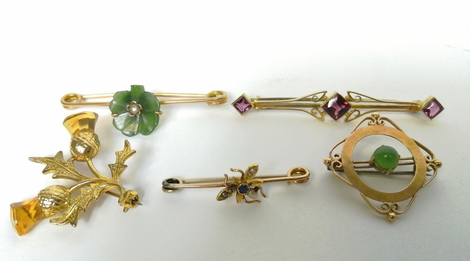 Five gold brooches, some gem set.