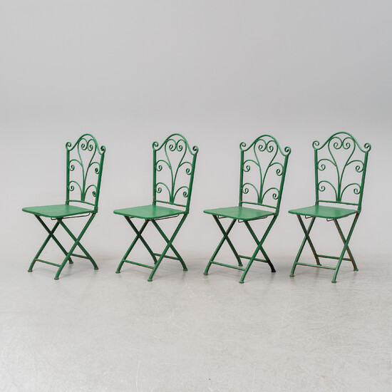 Four iron garden chairs.
