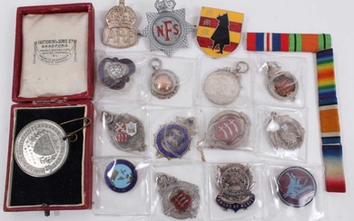 Group of silver fobs, military badges, medallion etc within a brass cigar box
