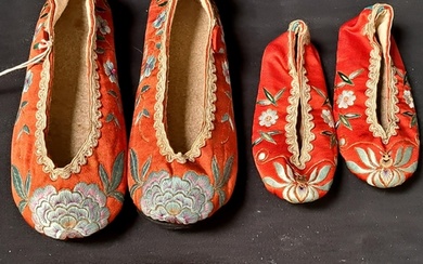 PAIR OF CHINESE RED SILK SLIPPERS decorated with floral moti...