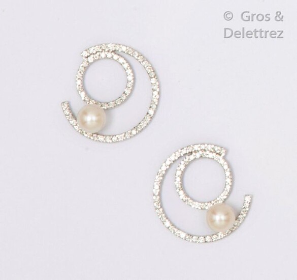Pair of white gold "Concentric" earrings, entirely set with brilliant-cut diamonds and finished with a cultured pearl. Stem clasp. Diameter: 2.4cm. Rough weight: 8.1g.