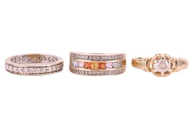 Three gem-set rings comprising a diamond-set full eternity ring in white metal tested as 9ct gold, s