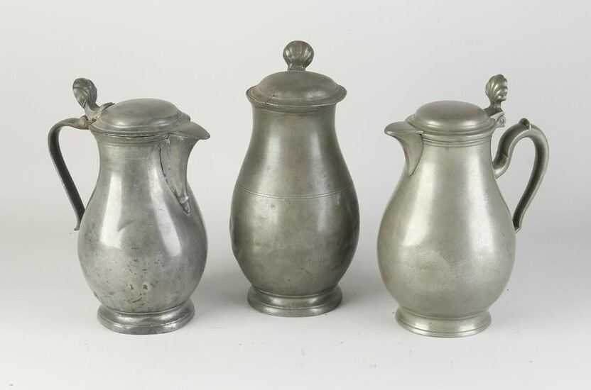 Three tin pitchers