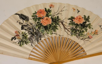 20th China. Large fan in ink and colour on paper decorated with birds, butterflies, rocks and peonies, inscription and stamp on the right. H: 71.5 cm (Small traces of moisture)