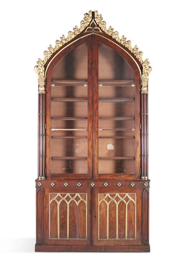 A REGENCY ROSEWOOD AND PARCEL GILT BOOKCASE, in...
