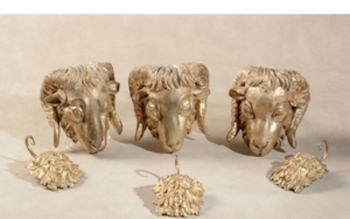 A set of three carved and gilt composition mounts modelled as rams’ masks