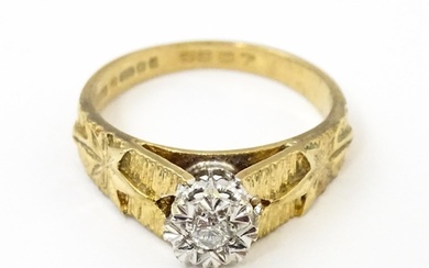 A 9ct gold ring set with central illusion set diamond with s...
